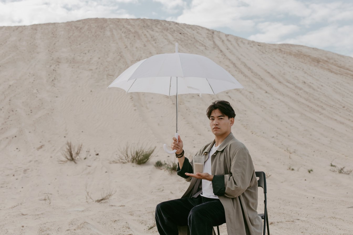 A Woman in Gray Long Sleeves Holding White Umbrella