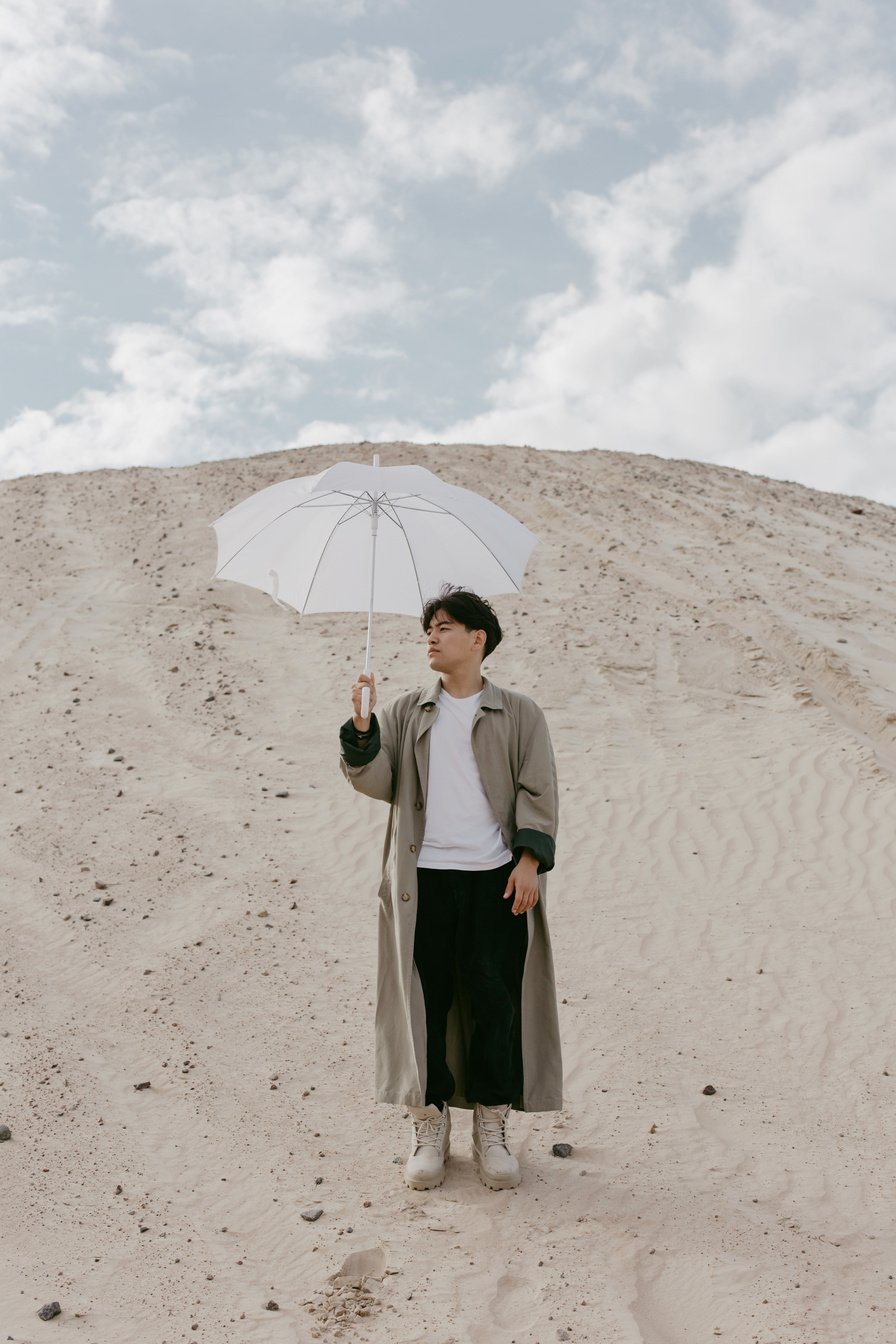 A Man Holding a White Umbrella